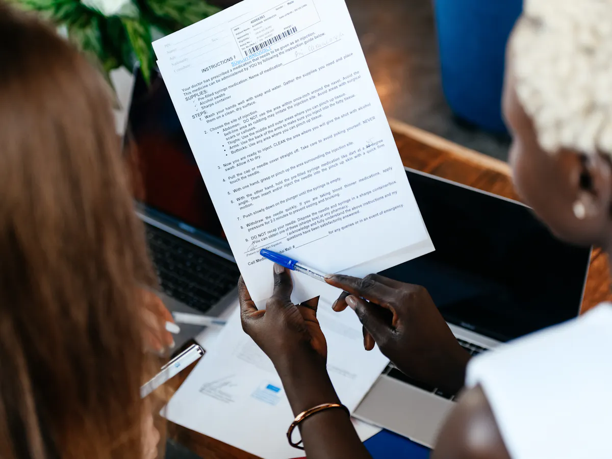Two people reviewing documents together at a desk